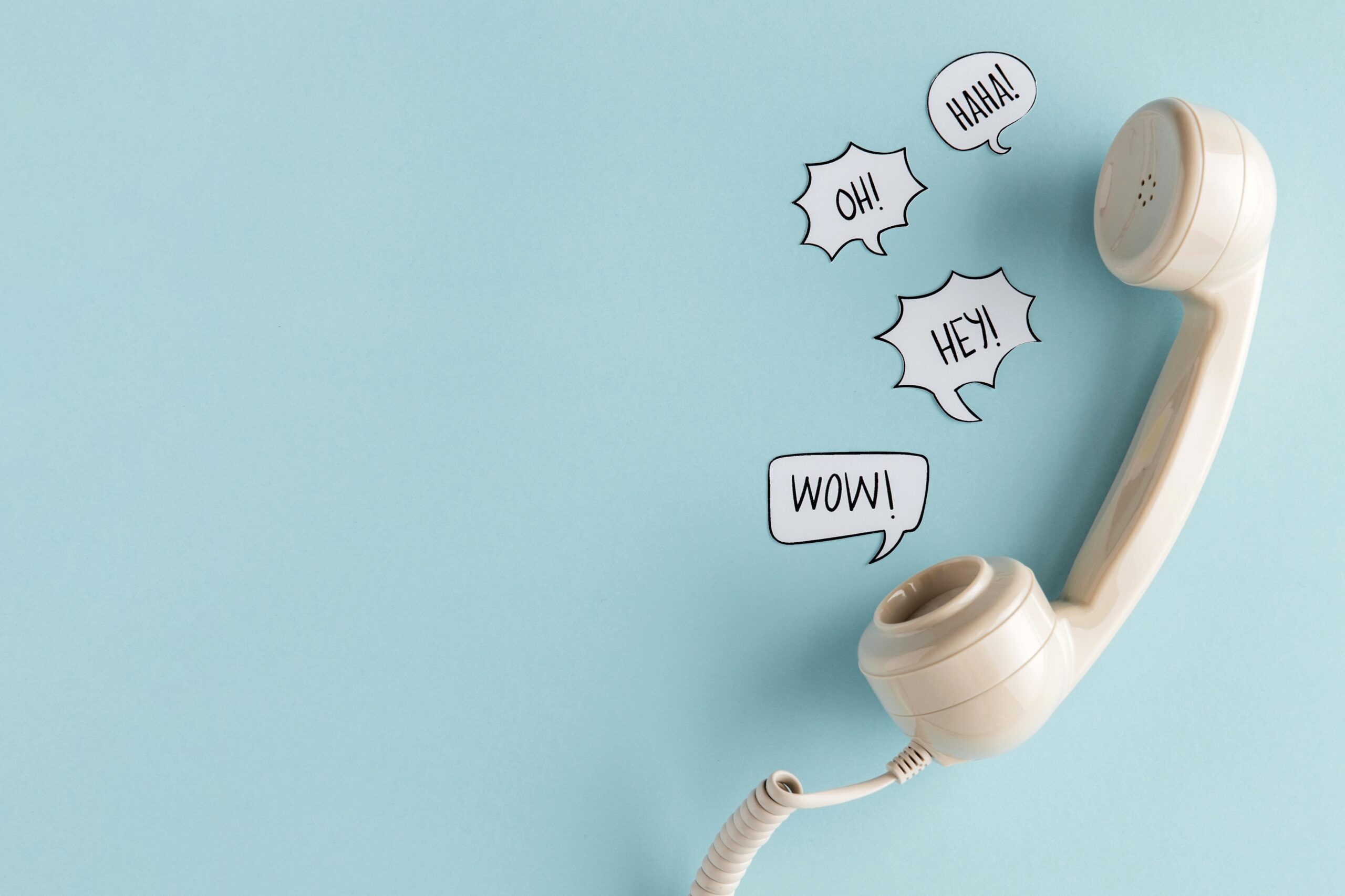 flat-lay-chat-bubbles-with-telephone-receiver-copy-space-min